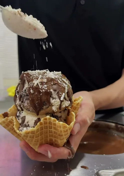 Nieve en canasta de barquillo con chocolate y coco rallado.